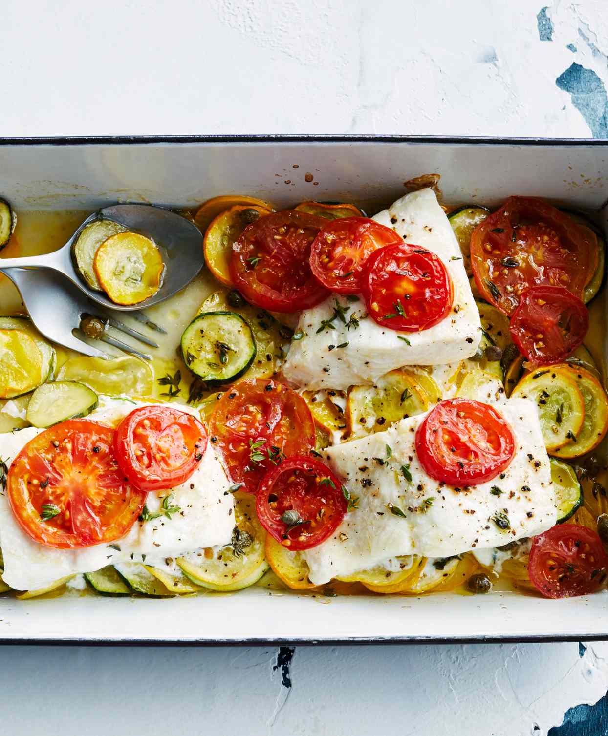 baked fish with summer squash topped with sliced tomatoes