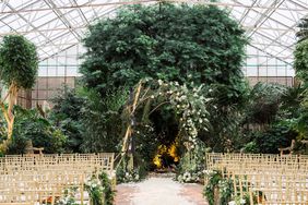 wedding ceremony greenhouse venue white flowers and greenery