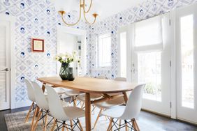 Classy dining room with toile wallpaper.