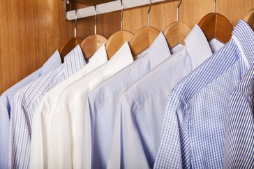 Colored shirts on wooden background.