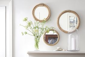 Rope-framed mirrors arranged on a wall