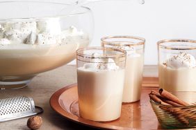 punch bowl and 3 glasses of eggnog on a tray