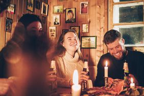 Group of friends around table drinking beer winter time