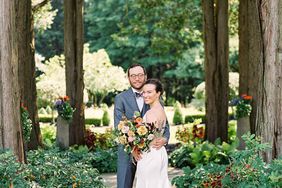 couple posing in wooded area