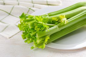 A bunch of celery on a white plate