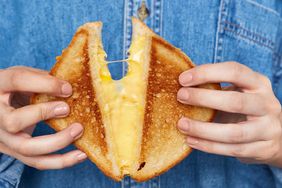 hands holding grilled cheese