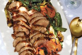 honey-glazed pork tenderloin with grilled apricots served on a white platter