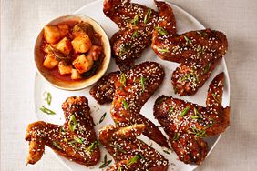 overhead view of korean fried chicken wings on white plate