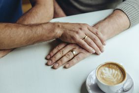 Same-sex couple with wedding bands