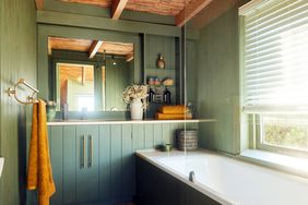 Green bathroom with orange towels