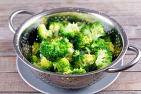 blanched broccoli in a metal colander