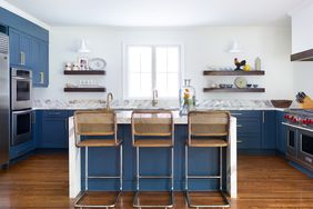 modern blue kitchen with island and open shelving