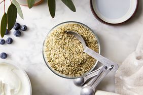 Hemp hearts in a bowl with measuring spoons