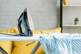 Iron and shirt on ironing board