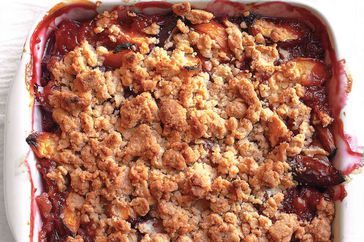 close up of peach crumble in white dish