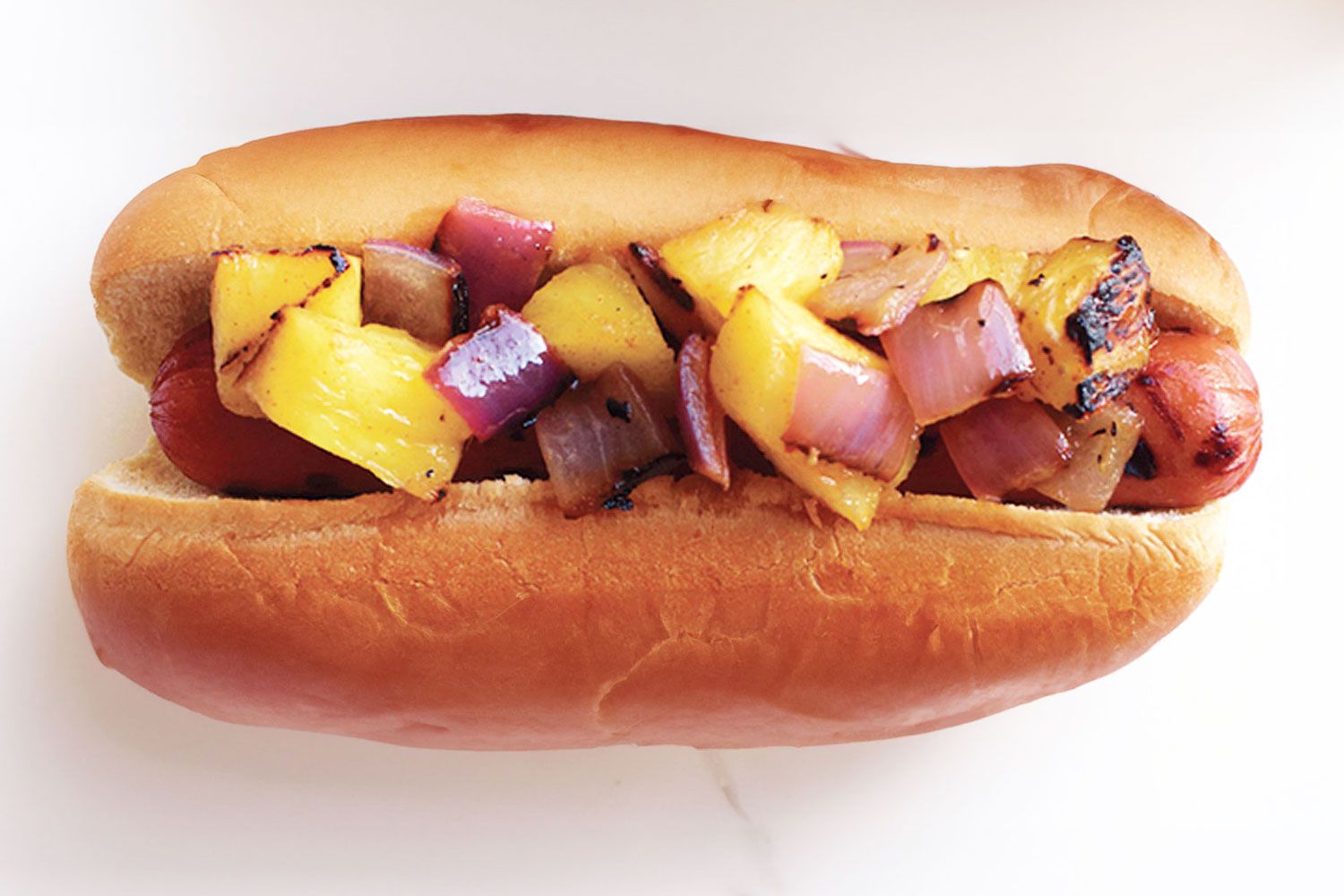 Hot dog with pineapple and onion