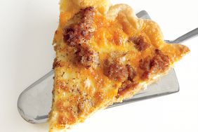 close up of a slice of sausage potato quiche