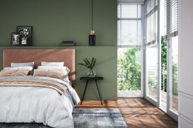 Modern interior of bedroom with green wall.