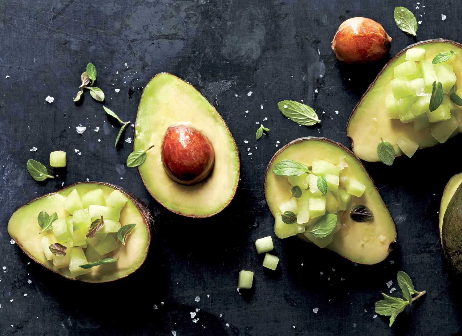 overhead view of halved avocados with chopped melon