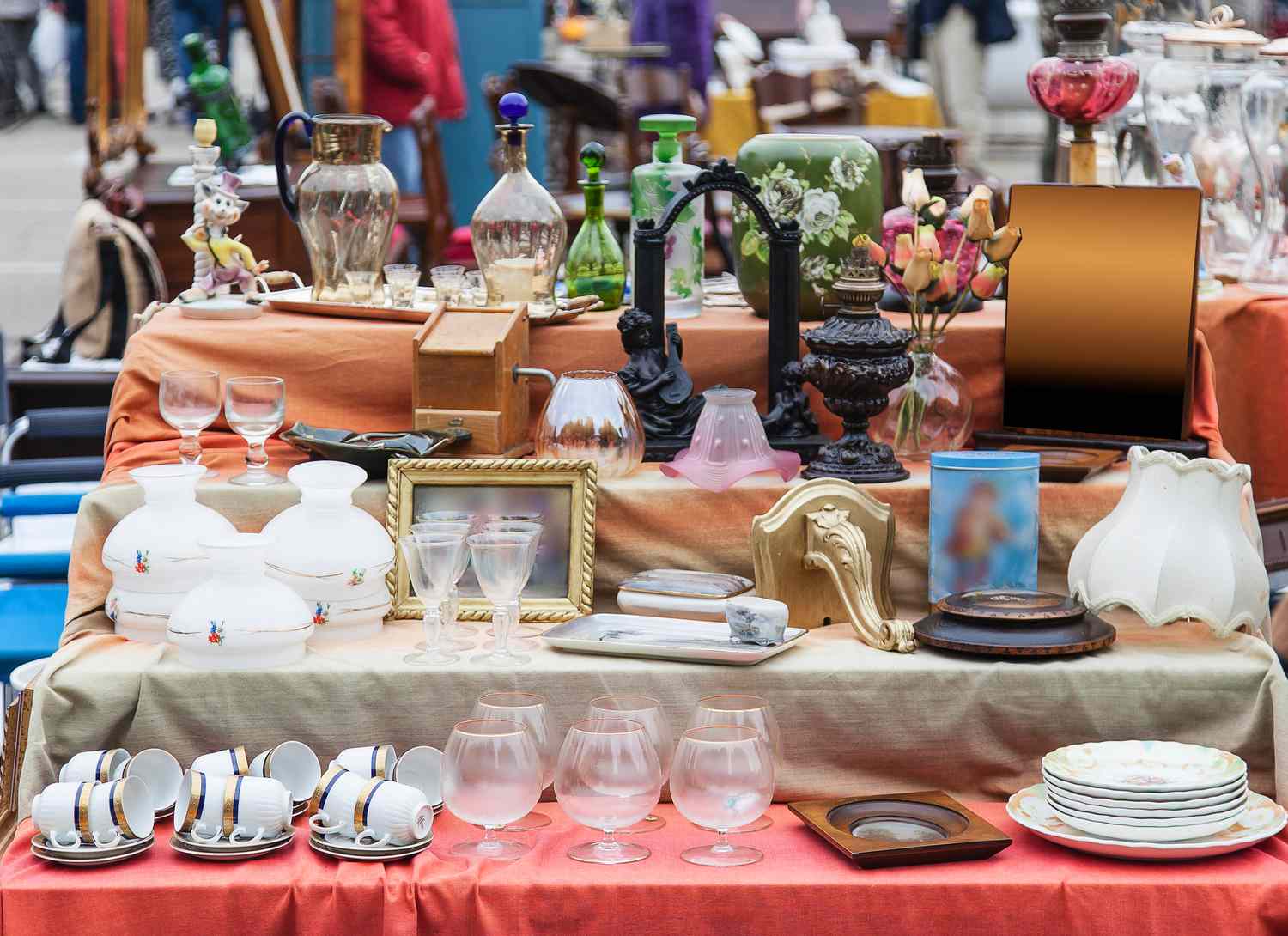 thrift store display table with dishes and objects