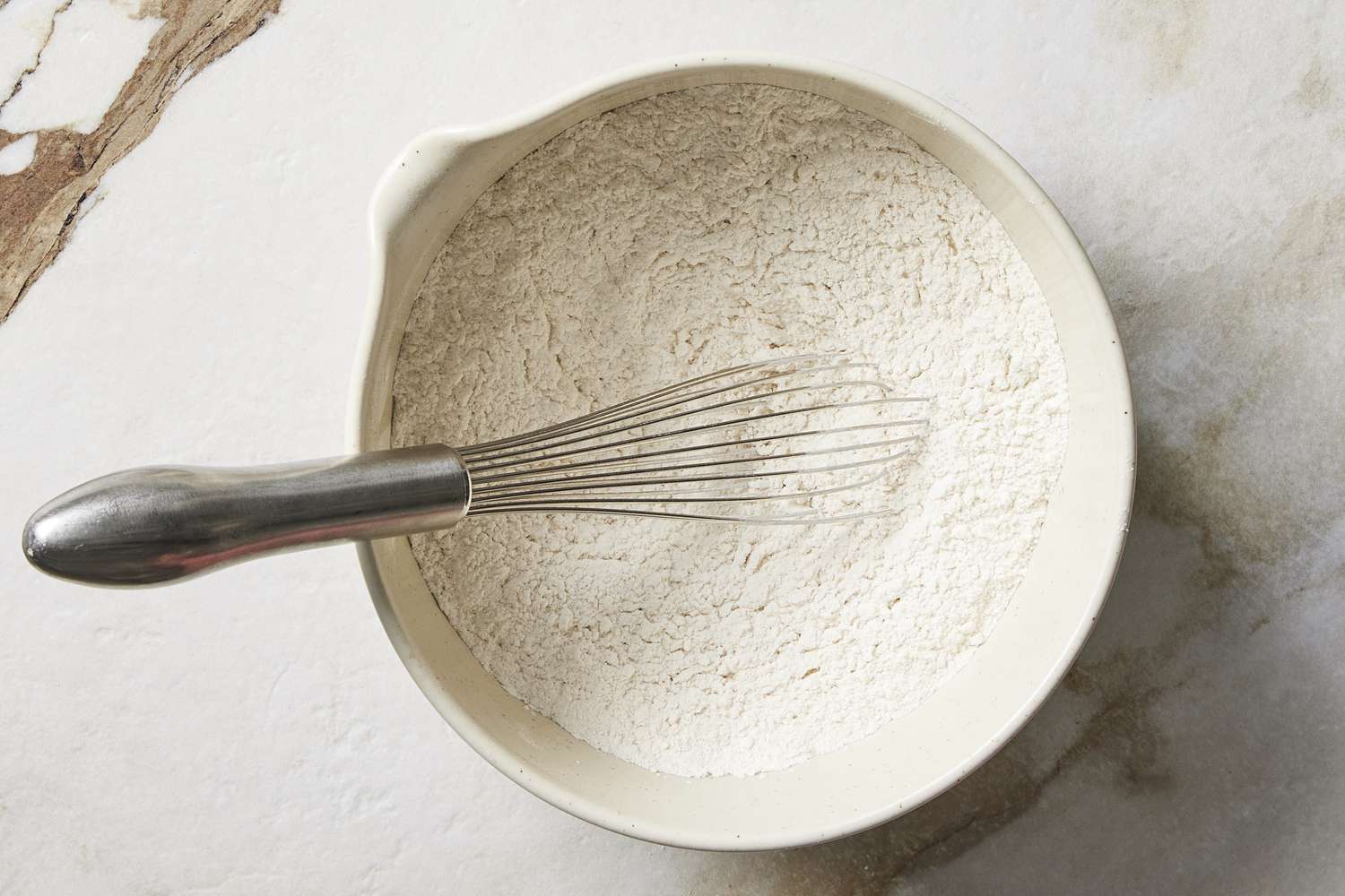 Flour in bowl with whisk