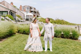 bride and groom holding hands wearing traditional indian attire