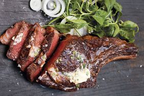 rib eye with jalapeno butter on a wooden surface