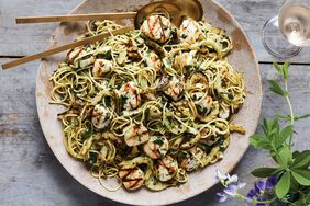 sea scallops over herb shallot pasta on a wooden tabletop