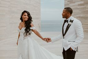 bride and groom walking together on modern structure at beach