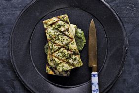 tofu with ginger cilantro sauce served on a black plate