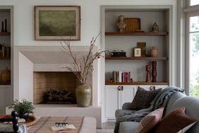 fireplace with wooden and white shelving grey sofa