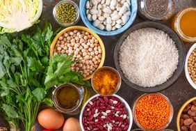 Legumes and greens laid out on table